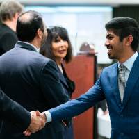 Dean Plotkowski congratulates a student